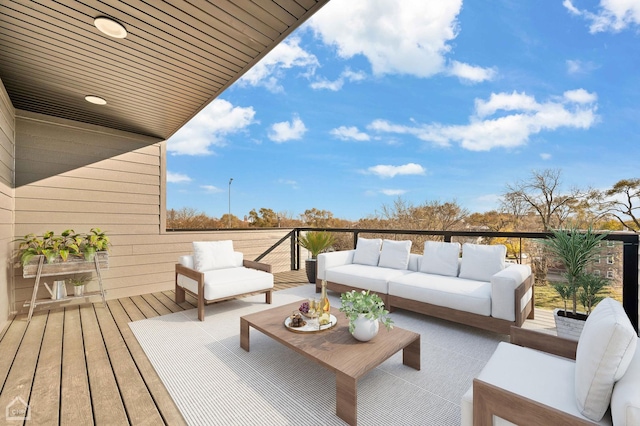 wooden terrace with an outdoor hangout area