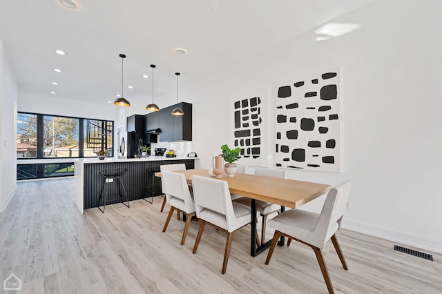 dining space featuring light wood-type flooring