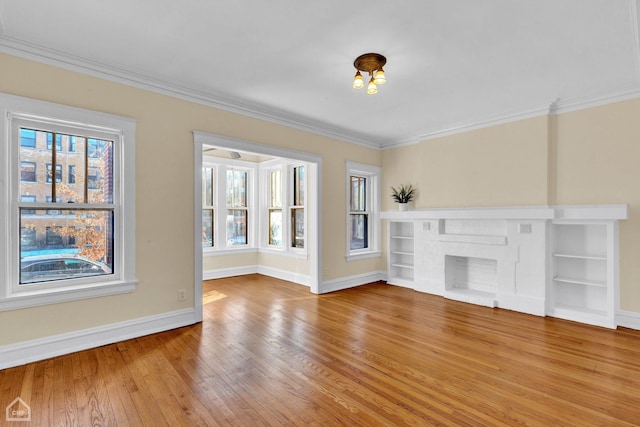 unfurnished living room with crown molding, hardwood / wood-style floors, and a fireplace