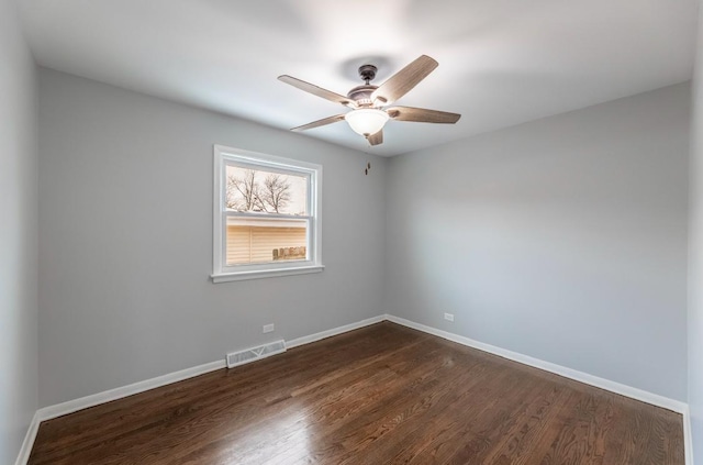 empty room with ceiling fan and dark hardwood / wood-style flooring