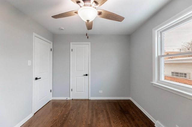 unfurnished bedroom featuring ceiling fan and dark hardwood / wood-style floors