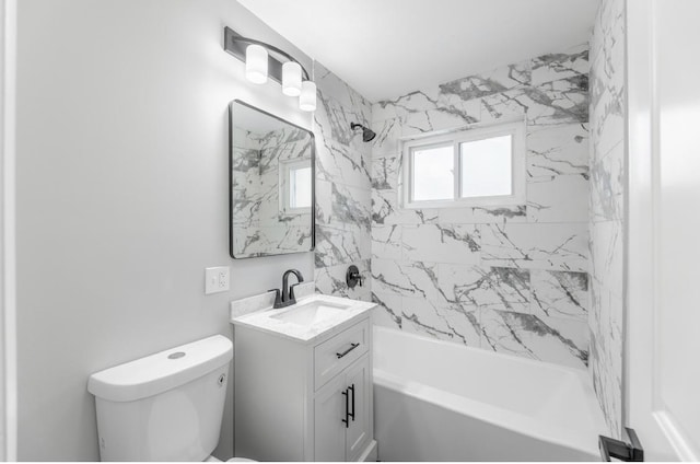 full bathroom featuring tiled shower / bath combo, vanity, and toilet