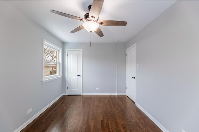 unfurnished room featuring ceiling fan and dark hardwood / wood-style flooring