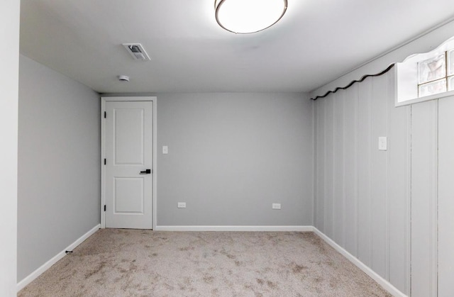 unfurnished room featuring light carpet