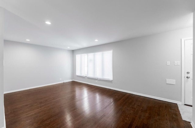 unfurnished room with dark wood-type flooring