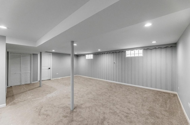 basement featuring light colored carpet