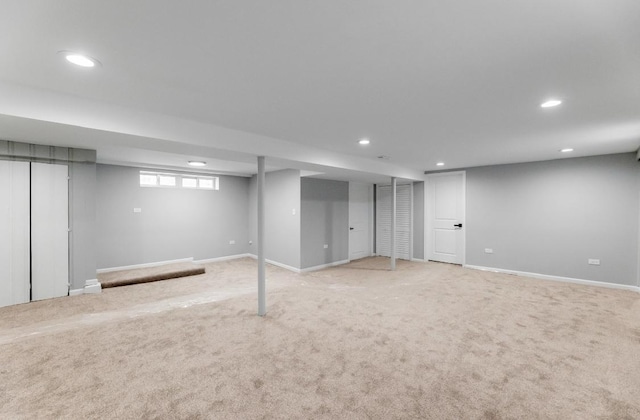 basement featuring light colored carpet