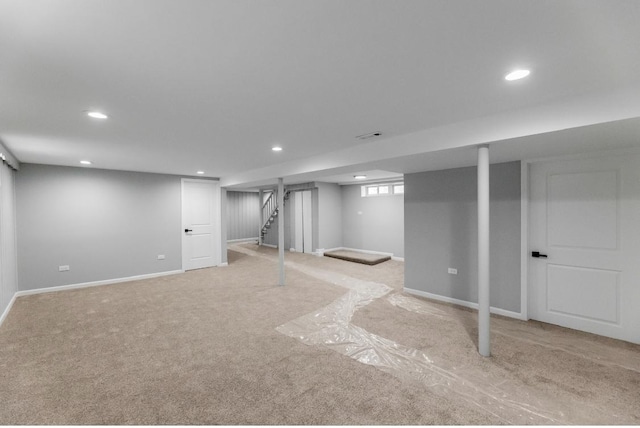 basement featuring light colored carpet