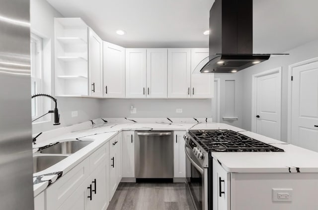 kitchen featuring sink, island exhaust hood, stainless steel appliances, white cabinets, and light stone counters