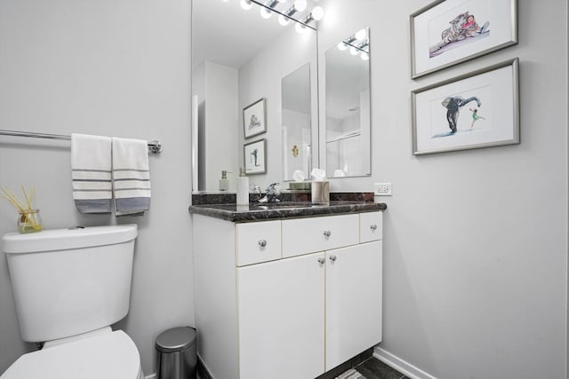 bathroom featuring vanity and toilet