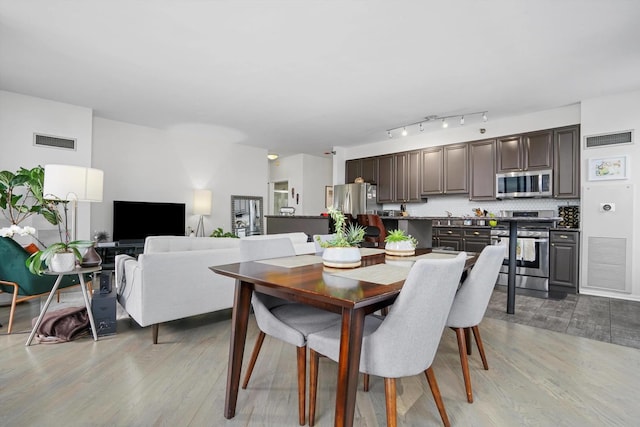 dining space featuring light hardwood / wood-style floors