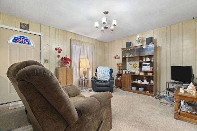 living room with carpet flooring, a chandelier, and a textured ceiling