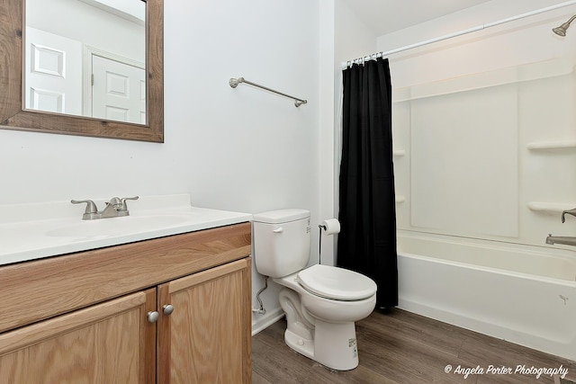 full bathroom with toilet, shower / bathtub combination with curtain, hardwood / wood-style flooring, and vanity