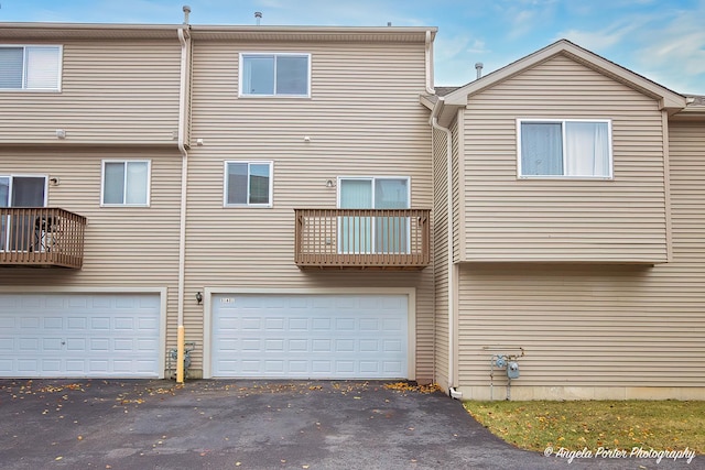 back of property featuring a garage