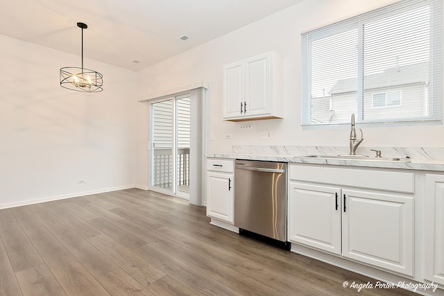 kitchen featuring white cabinets, dishwasher, decorative light fixtures, sink, and a chandelier