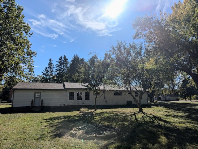 view of side of property with a lawn