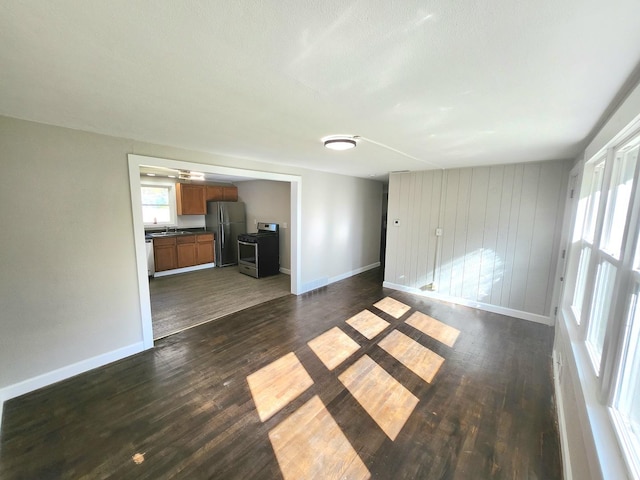 unfurnished living room with dark hardwood / wood-style floors