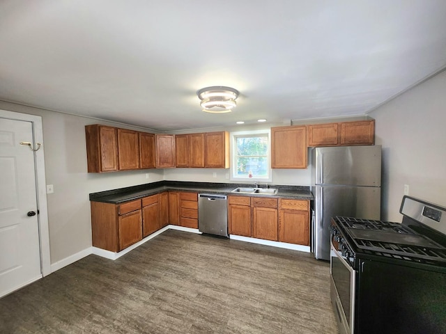 kitchen featuring appliances with stainless steel finishes, sink, and dark hardwood / wood-style floors