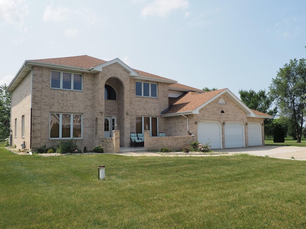 view of front facade with a front lawn and a garage