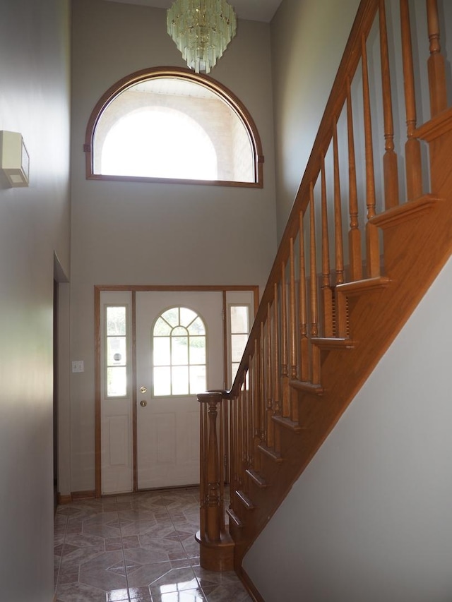 foyer entrance featuring a high ceiling and a chandelier