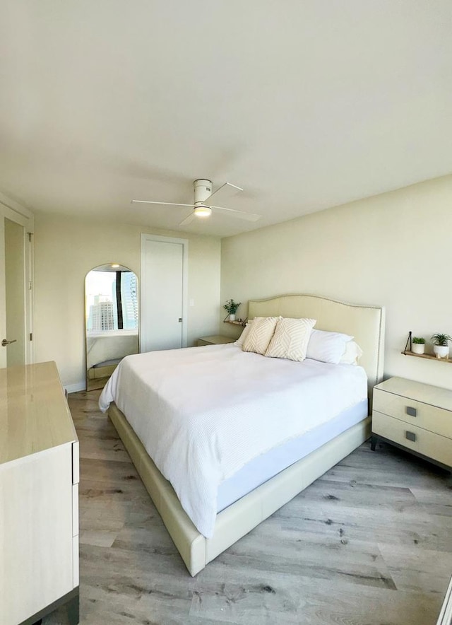 bedroom with ceiling fan and hardwood / wood-style floors