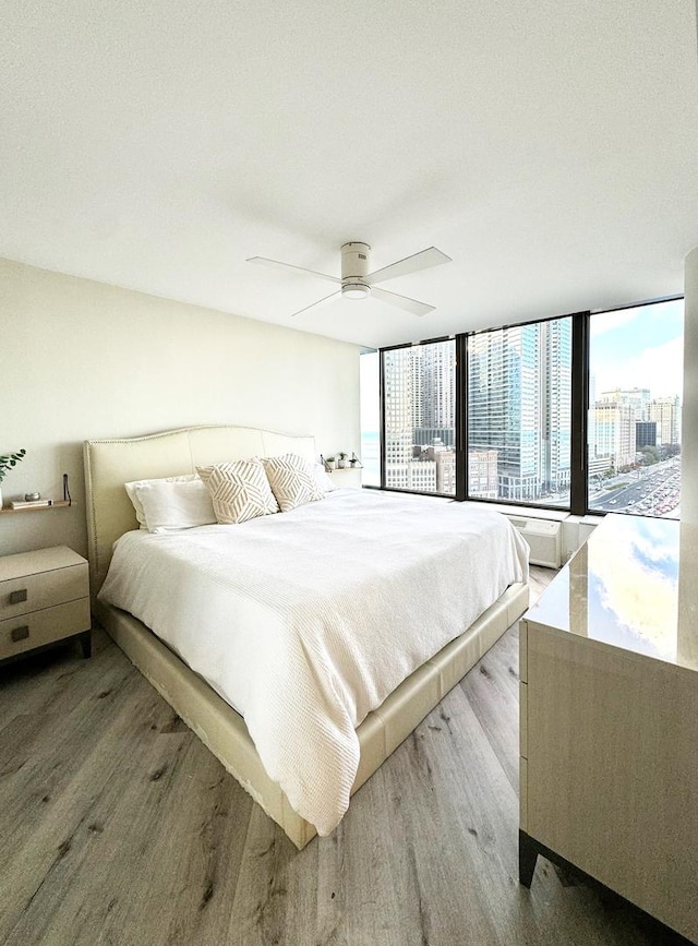 bedroom with light wood-type flooring and ceiling fan