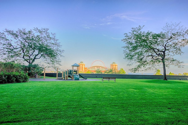 view of home's community with a playground and a lawn