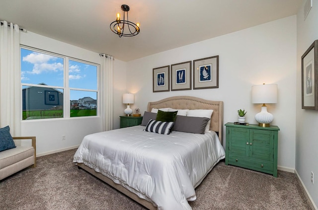 carpeted bedroom with a chandelier