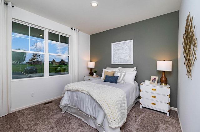 bedroom featuring dark carpet