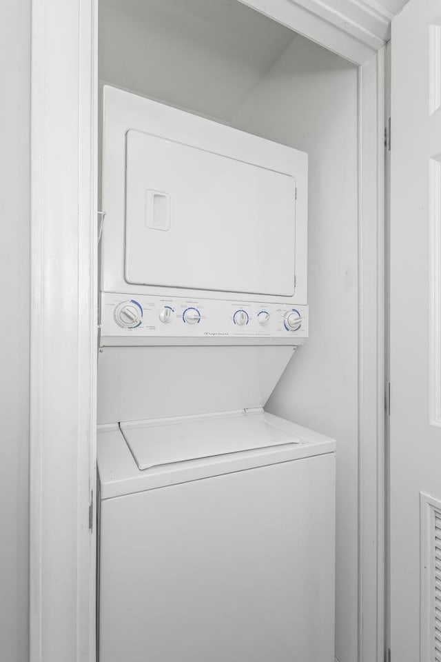 laundry area featuring stacked washer / dryer