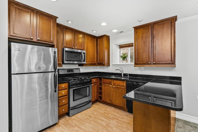 kitchen with stainless steel appliances, crown molding, light hardwood / wood-style floors, and sink