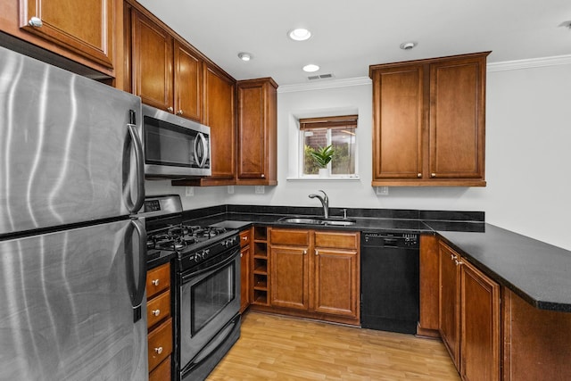 kitchen featuring appliances with stainless steel finishes, sink, ornamental molding, and light hardwood / wood-style floors