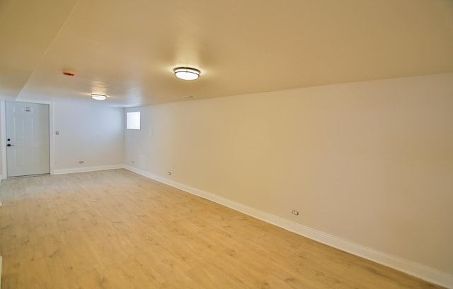 basement with hardwood / wood-style floors