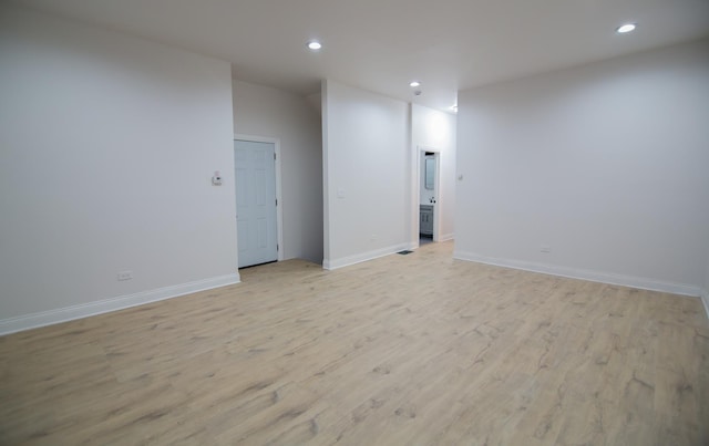 empty room with light hardwood / wood-style flooring