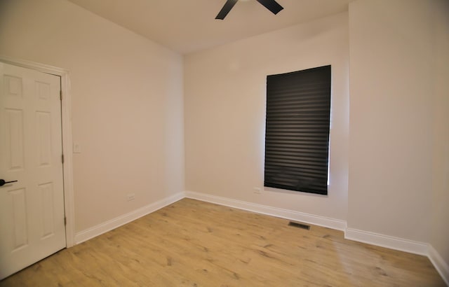 spare room with light wood-type flooring and ceiling fan