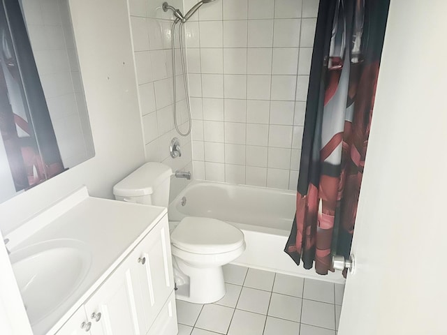 full bathroom featuring toilet, vanity, tile patterned floors, and shower / bath combo with shower curtain