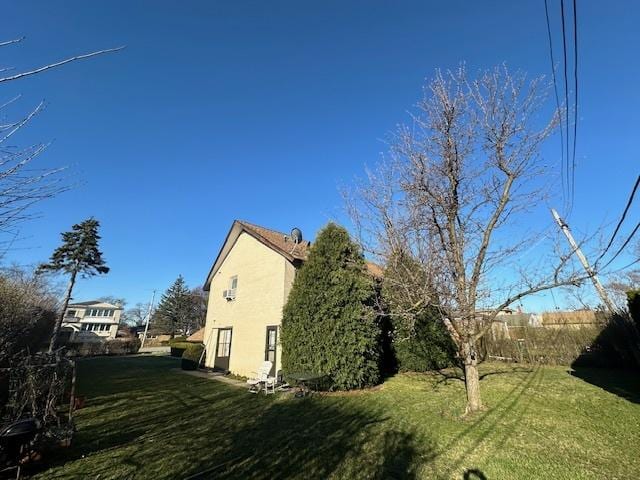 view of side of home featuring a yard