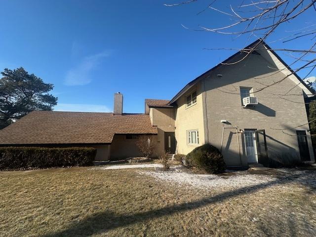 back of house with a lawn