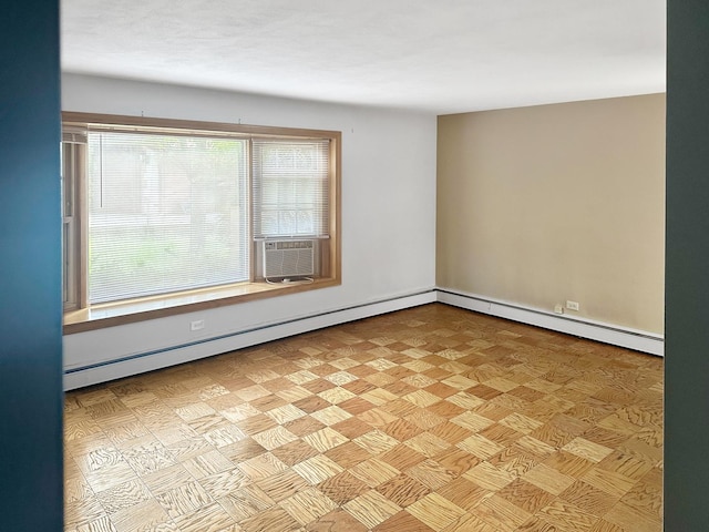 empty room featuring baseboard heating, a wealth of natural light, and cooling unit