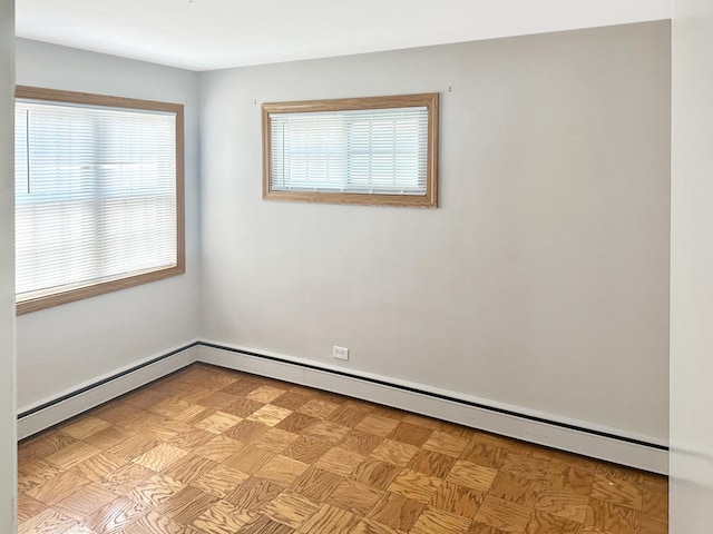 unfurnished room with baseboard heating