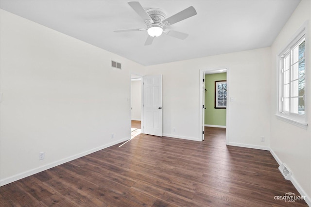 empty room featuring ceiling fan and dark hardwood / wood-style floors