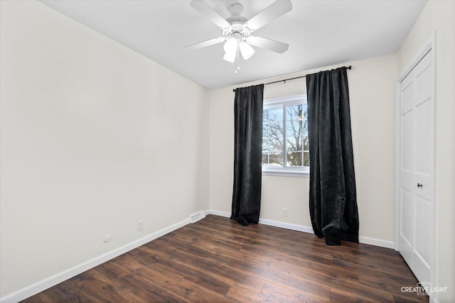 spare room featuring ceiling fan and dark hardwood / wood-style flooring