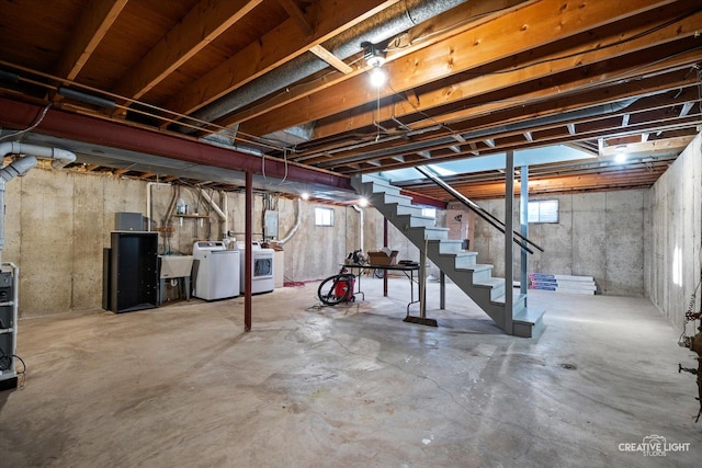 basement with sink, electric panel, and washing machine and dryer