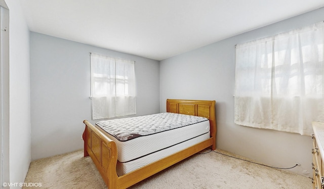 bedroom with light colored carpet