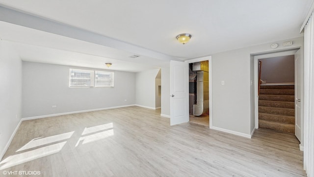 interior space with a closet, a walk in closet, and light wood-type flooring