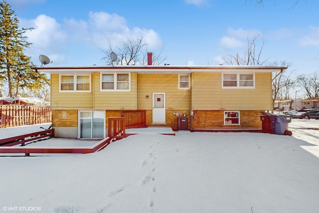 view of snow covered rear of property