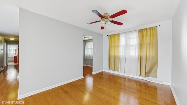 spare room with ceiling fan and wood-type flooring