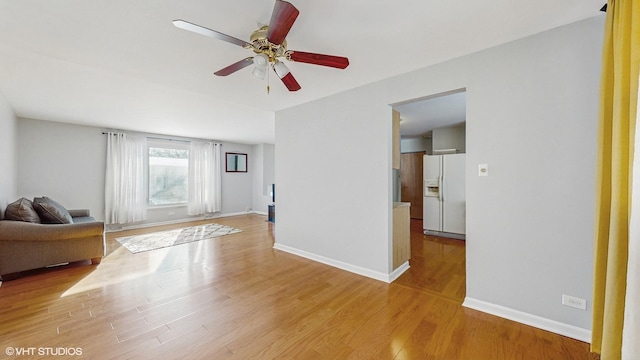 unfurnished living room with ceiling fan and light hardwood / wood-style flooring