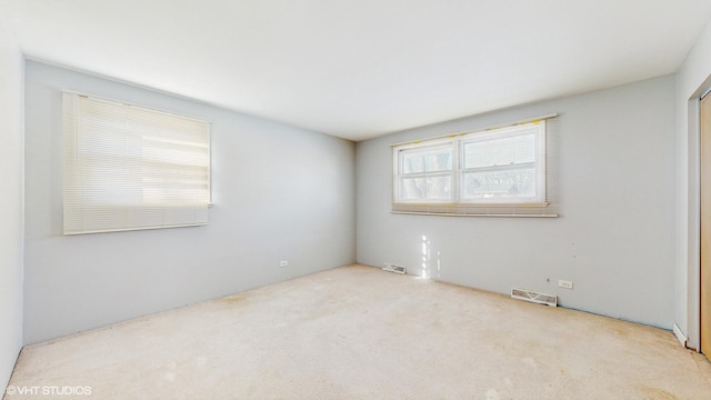 spare room with light colored carpet