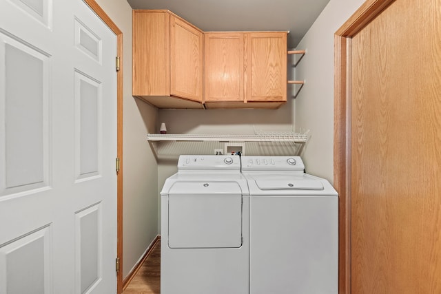 laundry area with washer and dryer and cabinets